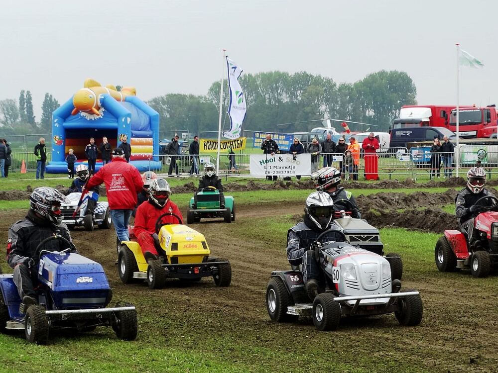 Buitenevenement op een grasveld in Rockanje met deelnemers, publiek en een springkussen